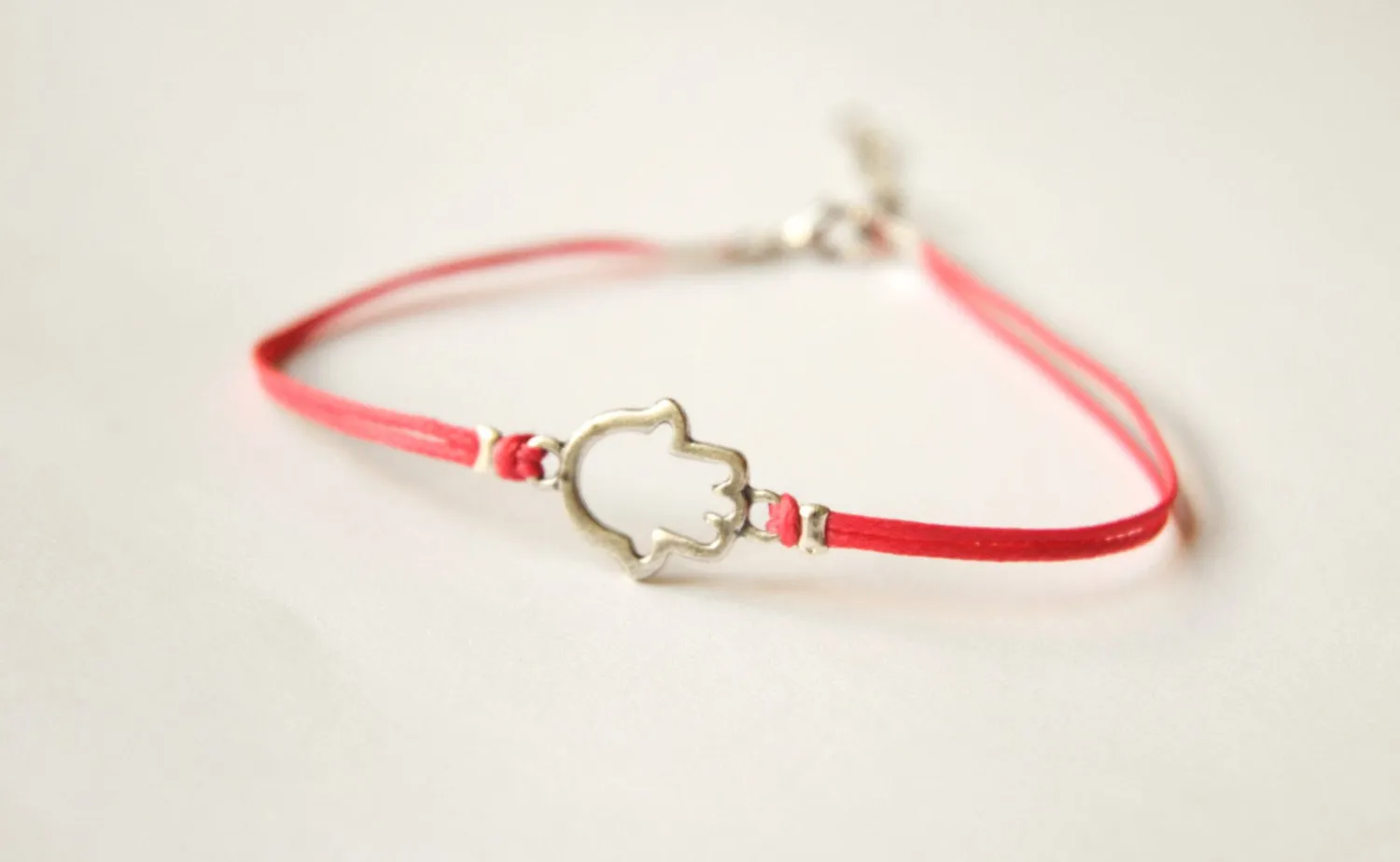 Pink dainty cord anklet with a silver Hamsa charm, hand of Fatima, evil eye protection